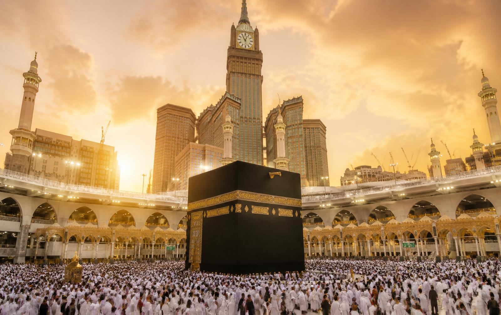 Pilgrims circling the Kaaba in Masjid al-Haram at golden hour
